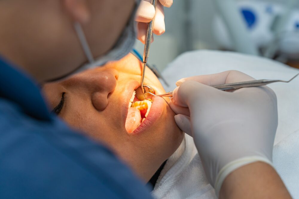 Dentist examining a patient during an emergency dental visit in McKinney, TX